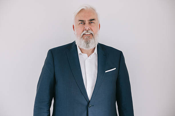istock Confident mature man in professional attire against a simple white background 2243968676