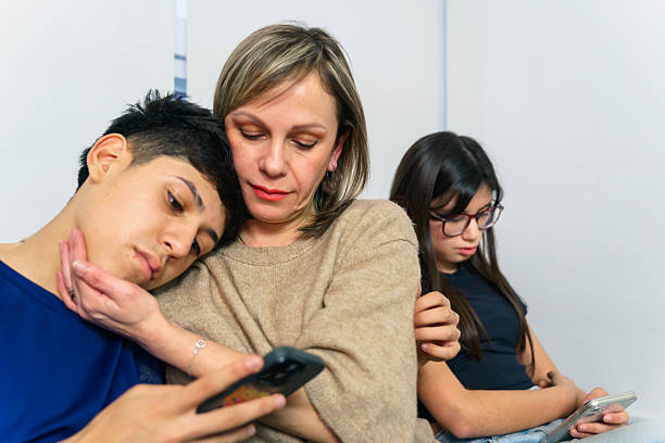 istock Family distracted by phones, everyone using mobile devices 2243969503