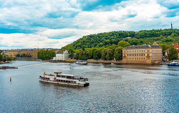 istock Tour Boats Passing Historic Prague Waterfront Building. 2243970258