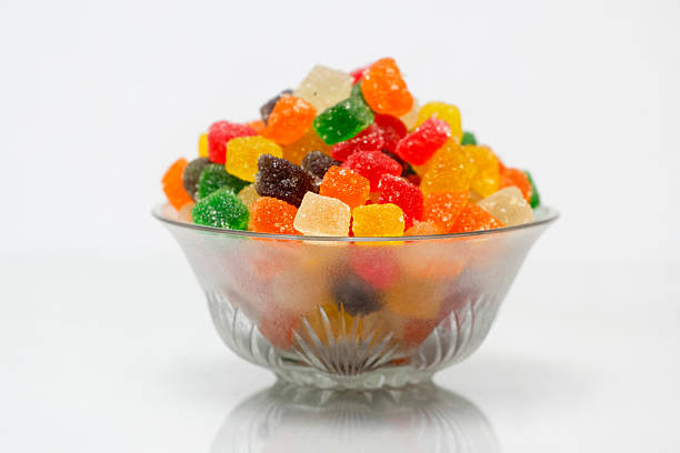 Bright and colorful sugar-coated tutti frutti cubes served in a glass bowl, perfect for desserts and sweets.