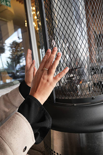 Warm hands gathered around a cozy heater in a cafe