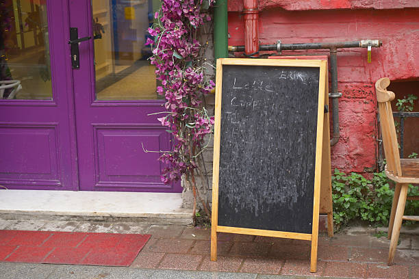 istock Chalkboard menu stands outside a colorful cafe 2243971389