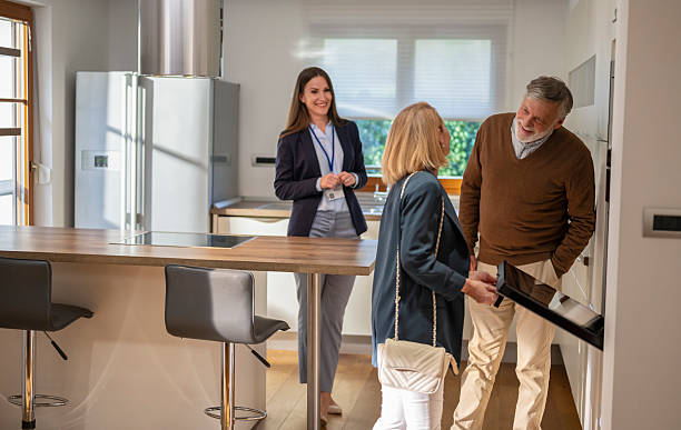 istock Senior couple checking kitchen at real estate showing 2243972404