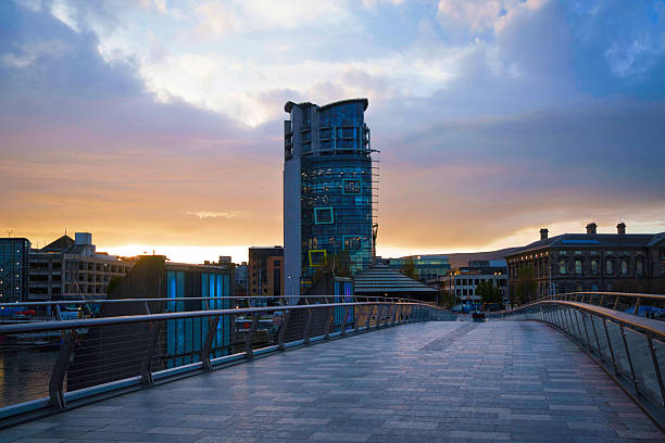 istock Belfast evening skyline with tall buildings and a dramatic sky over the River Lagan, viewed from the historic Lagan Weir Bridge in Northern Ireland. 2243975541