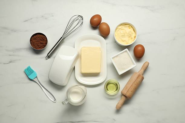 istock Flat lay composition with fresh butter among other products on white marble table 2243975561