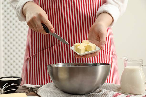 istock Woman adding fresh butter into bowl at table, closeup 2243975593