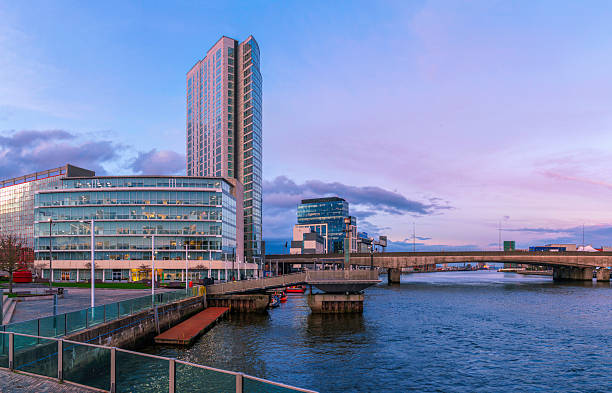 istock Belfast evening skyline with tall buildings and a dramatic sky over the River Lagan, viewed from the historic Lagan Weir Bridge in Northern Ireland. 2243975691