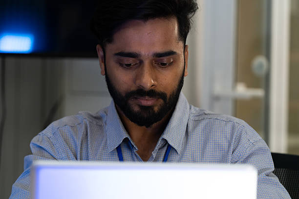 istock Business team analyzing data on laptops with growth chart in background. Diverse professionals collaborating in office, discussing financial performance, strategy, and success analytics in modern workplace. 2243977052