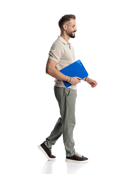 istock happy casual man with clipboard smiling and walking 2243980842