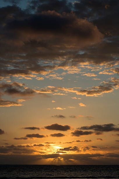 Sunrising in cloudy skies over the Alantic Ocean at Nags Head, in Outer Banks, North Carolina, USA
