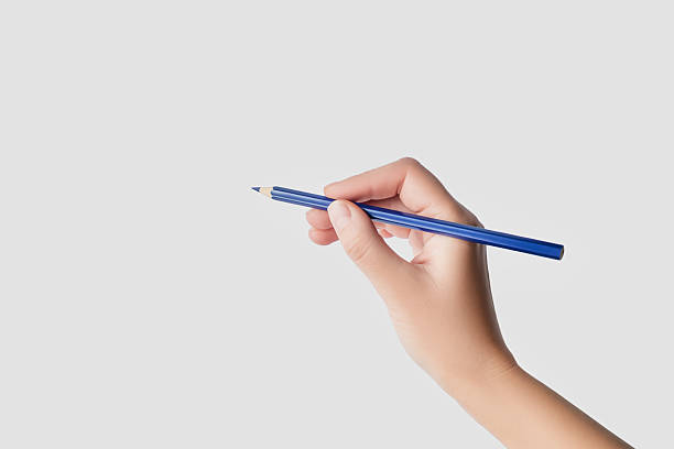 istock Hand Holding a Blue Pencil Ready to Write or Draw 2243983207
