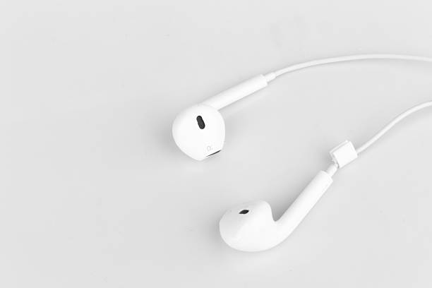 istock White earphones on white background 2243987443