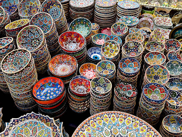 istock Colorful handmade ceramic bowls with traditional oriental patterns displayed at a market. Souvenir and decor concept. Top view. 2243988134