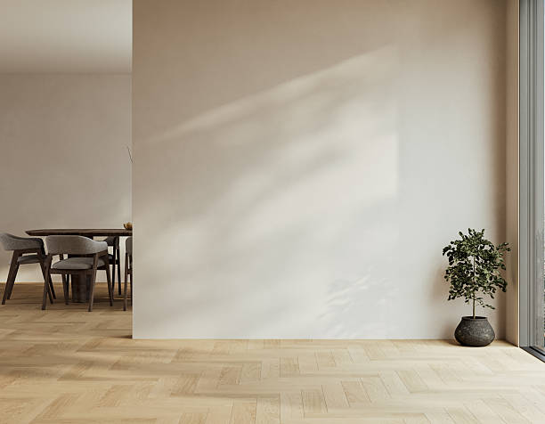 istock Minimal empty interior with herringbone oak flooring, beige walls, and soft natural light creating calm shadows. 3D rendering 2243989917