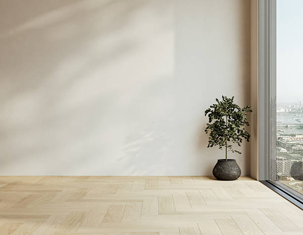 istock Bright empty interior with herringbone oak flooring, potted plant, and large city view window under natural light. 3D rendering 2243989992