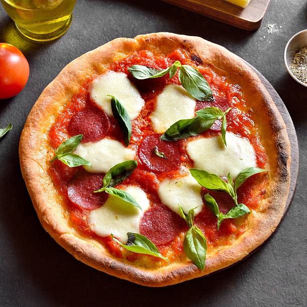 istock Pizza with mozzarella, pepperoni, tomato sauce and basil 2243991047