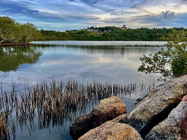 istock Tranquil Lagoon with Rocky Shore and Distant Hills 2243991489