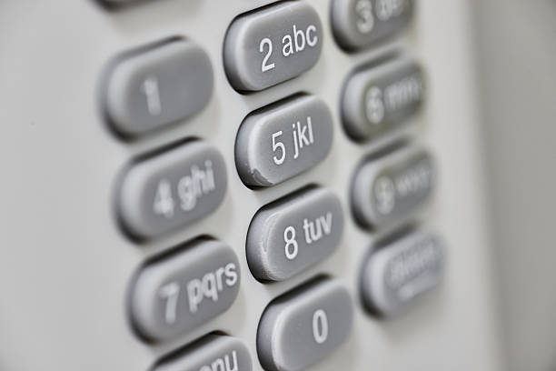 Macro shot of a light-colored keypad focusing on number 5, symbolizing communication and security in everyday technology.