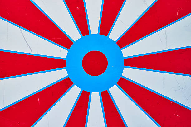 Bold sunburst pattern with vibrant red, white, and blue radiates energy from a textured surface, evoking Americana and a sense of target precision.