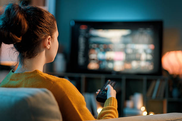 istock woman watching TV at home 2243995800