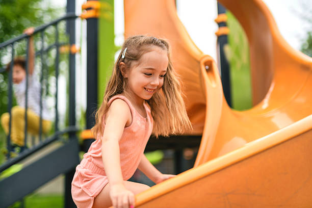 istock Happy kid slide on playground on summer season 2243996868