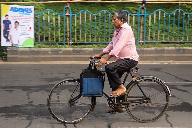 A traditionally dressed man rides a motorcycle through a Kolkata street during the morning rush, captured with a motion blur effect that highlights speed, movement, and the rhythm of city life.Bus at  Kolkata street during the morning rush, captured with a motion blur effect that highlights speed, movement, and the rhythm of city life.