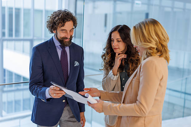 istock Business people discussing documents in modern office building 2243999310