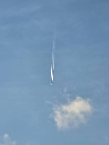 istock Jet Contrail Streaks Across Clear Blue Sky 2243999385