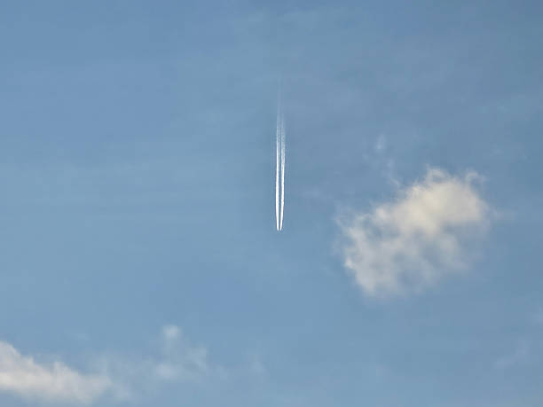 istock Jet Contrail Streaks Across Clear Blue Sky 2243999390