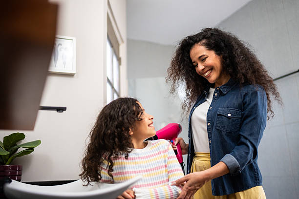istock Mother drying daughter's hair at home 2243999507