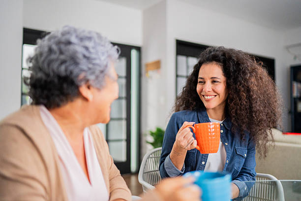 istock Mother and daughter talking during afternoon coffee at home 2244004228