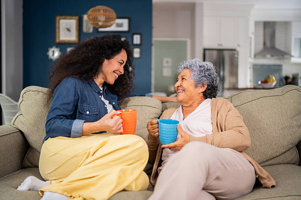 istock Mother and daughter talking during afternoon coffee at home 2244004236