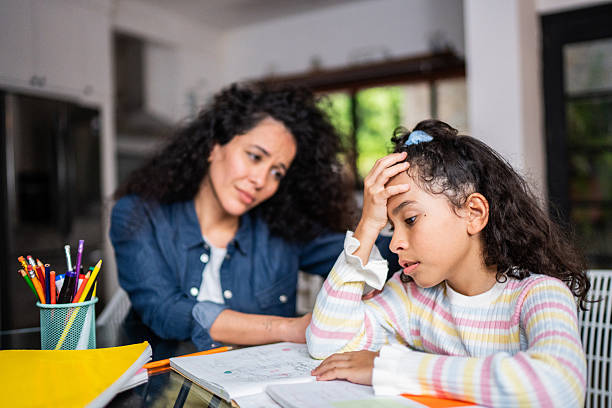 istock Worried child girl having difficulty with homework at home 2244004375