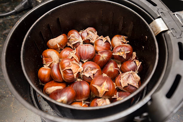 istock Detail of medium sized roasted chestnuts isolated. 2244005690