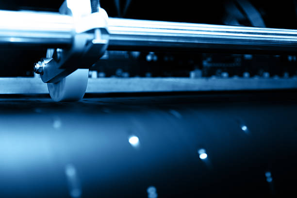 One hand is using a paper cutter to cut white paper.