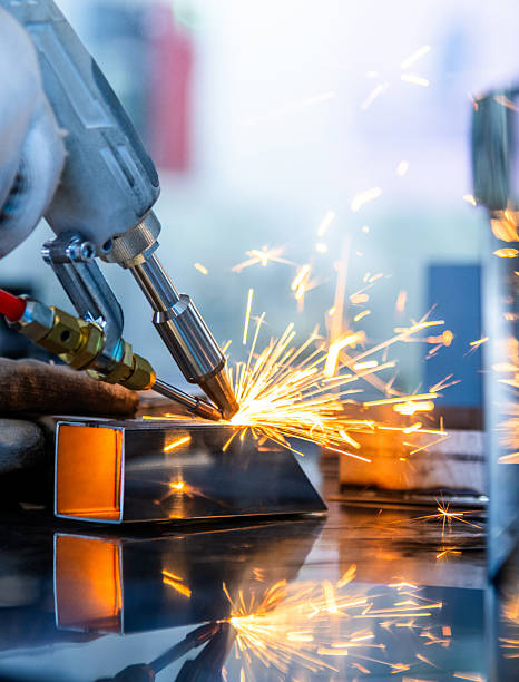 Close up of welder in a factory welding steel bars