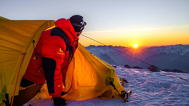 istock Solitary Climber in Red Jacket at Sunrise on Snowy Peak 2244007699