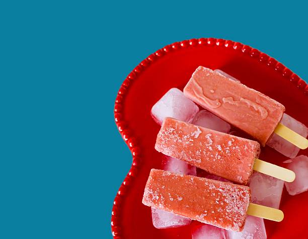 Fruit popsicle photography with a modern,  blue retro-style background for an artistic and modern aesthetic. Refreshing spring summer concept