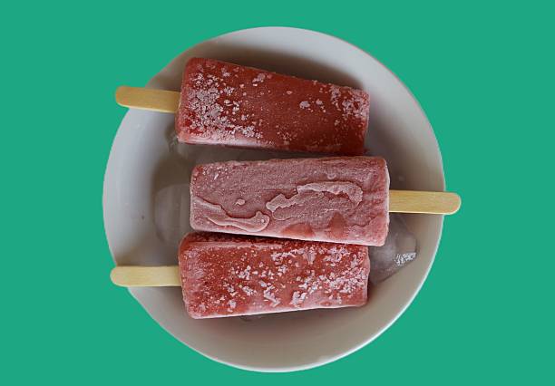 Fruit popsicle photography with a modern,  blue retro-style background for an artistic and modern aesthetic. Refreshing spring summer concept