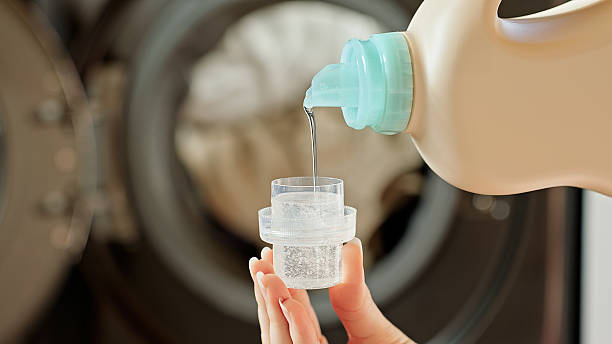istock A woman pours liquid laundry detergent into a cap. 2244013922