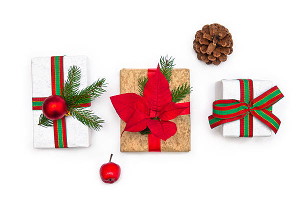 istock Three Christmas gift boxes with icy raindrops, pine cone and red apple on white background, top view flat lay with copy space 2244015549