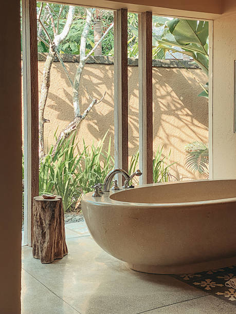 istock A beautiful stone bathtub in a bathroom with glass window 2244016378