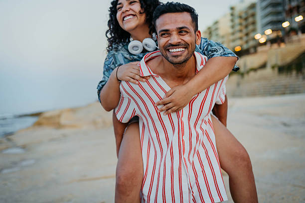 istock Lovely couple spending time together on beach 2244022161
