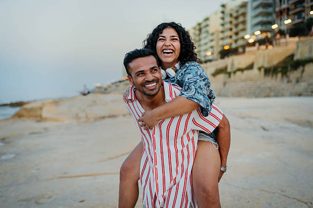 istock Lovely couple spending time together on beach 2244022340