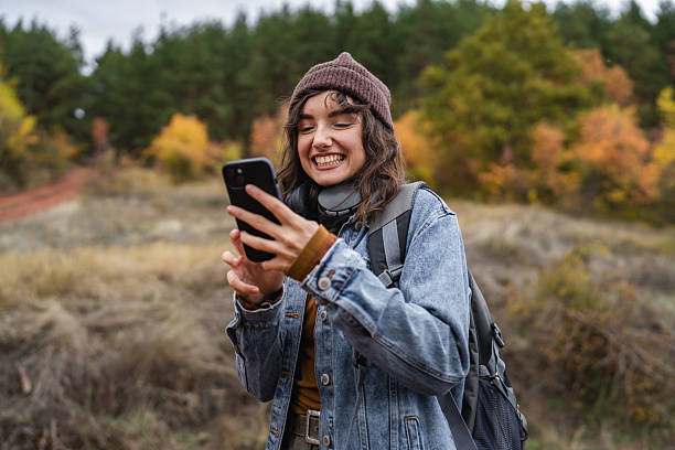 istock Young woman hiking, using smart phone in nature 2244023146