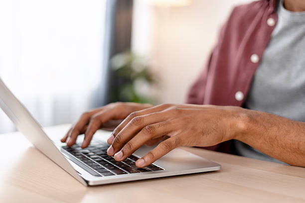 istock Copywriter typing on keyboard using laptop working at home in living room selective focus on hands 2244024075