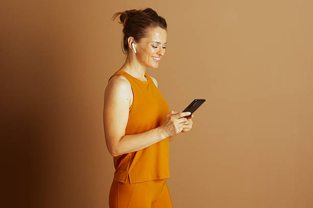 istock Active Woman Engaged with Smartphone in Profile 2244024132
