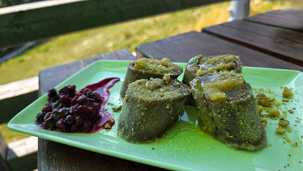 Buckwheat dumpling stuffed with walnuts and blueberries on wooden desk served in mountain hut outdoors.