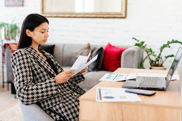 istock Woman in home office, documents and laptop for research in remote work 2244027115