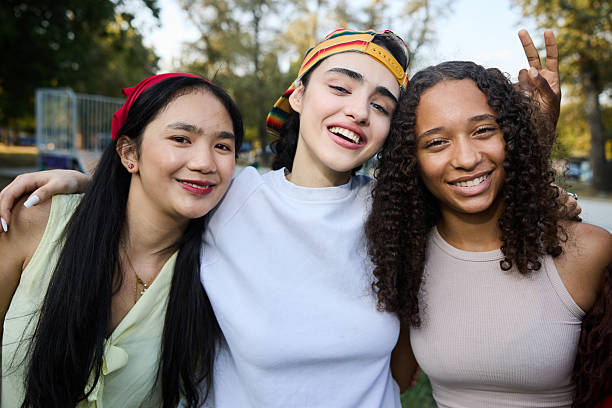 istock Smiling Friends Posing Together Outdoors During A Bright Sunny Day 2244027560